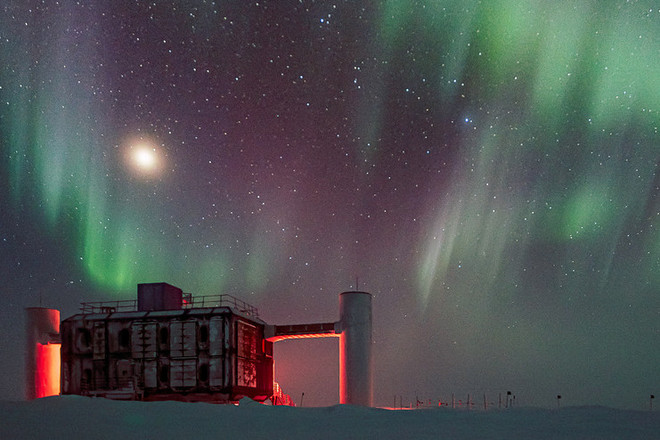 Das IceCube Neutrino Observatory bei Nacht mit Polarlichtern am Himmel